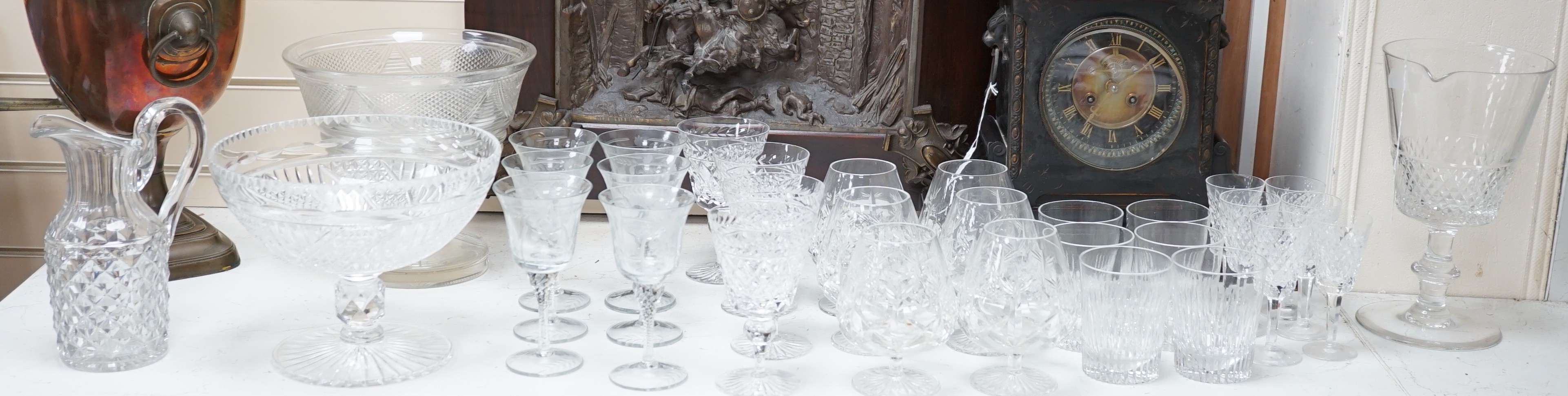 Assorted suites of cut glass wine glasses, brandy balloons, a pedestal water jug, two pedestal bowls